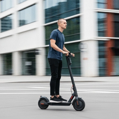 Person riding a Segway Ninebot Max G2 electric scooter on a city street